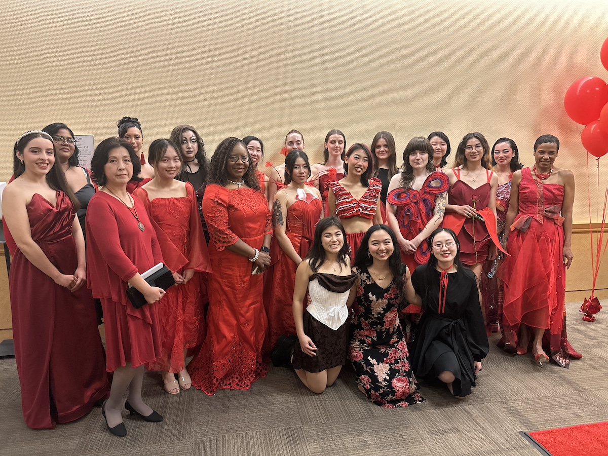 Adele Zhang (second to left), Estella Atekwana (fourth to left) and LeShelle May (far right) posed with student desingers and models who participated in the UC Davis Red Dress Collection fashion show on February 2nd.