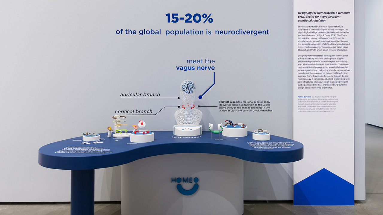 Interactive museum exhibit with blue curved table, clear dome and small models.
