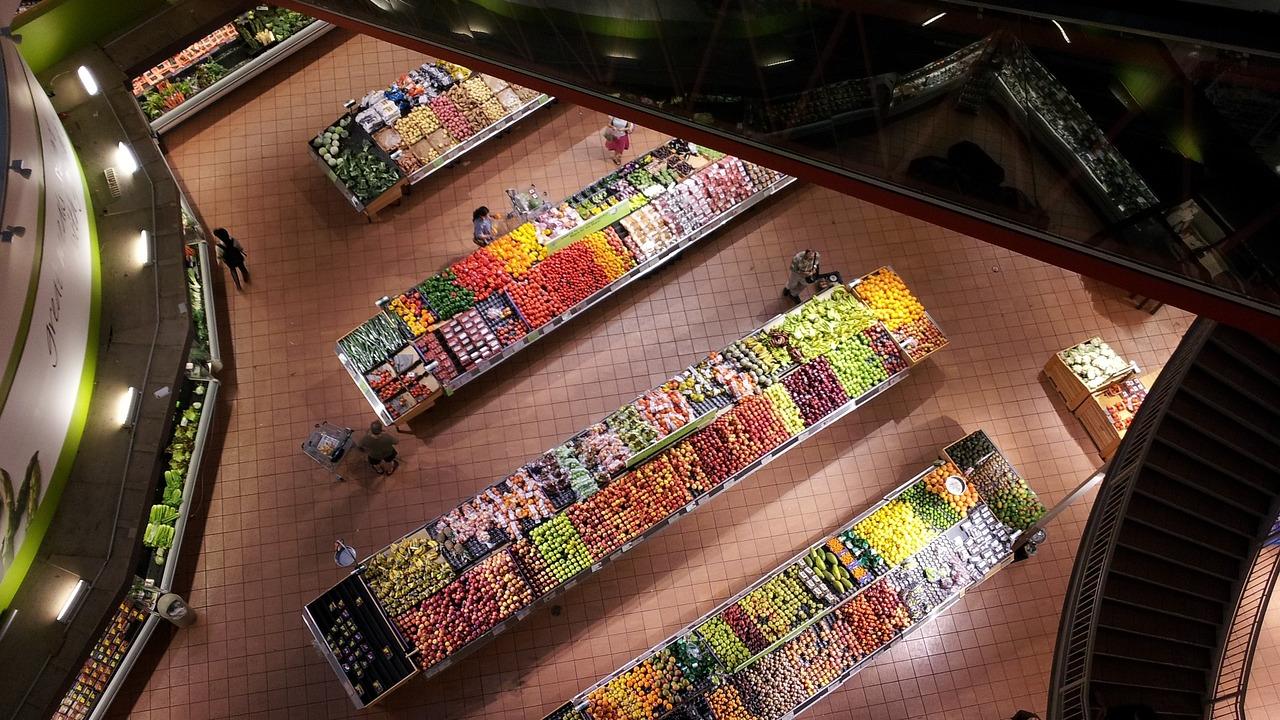 An overhead view of the produce section of a grocery store. 