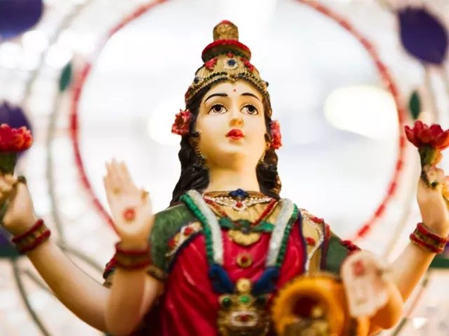 a statue of the goddess Sri-Lakshmi holding lotus flowers.