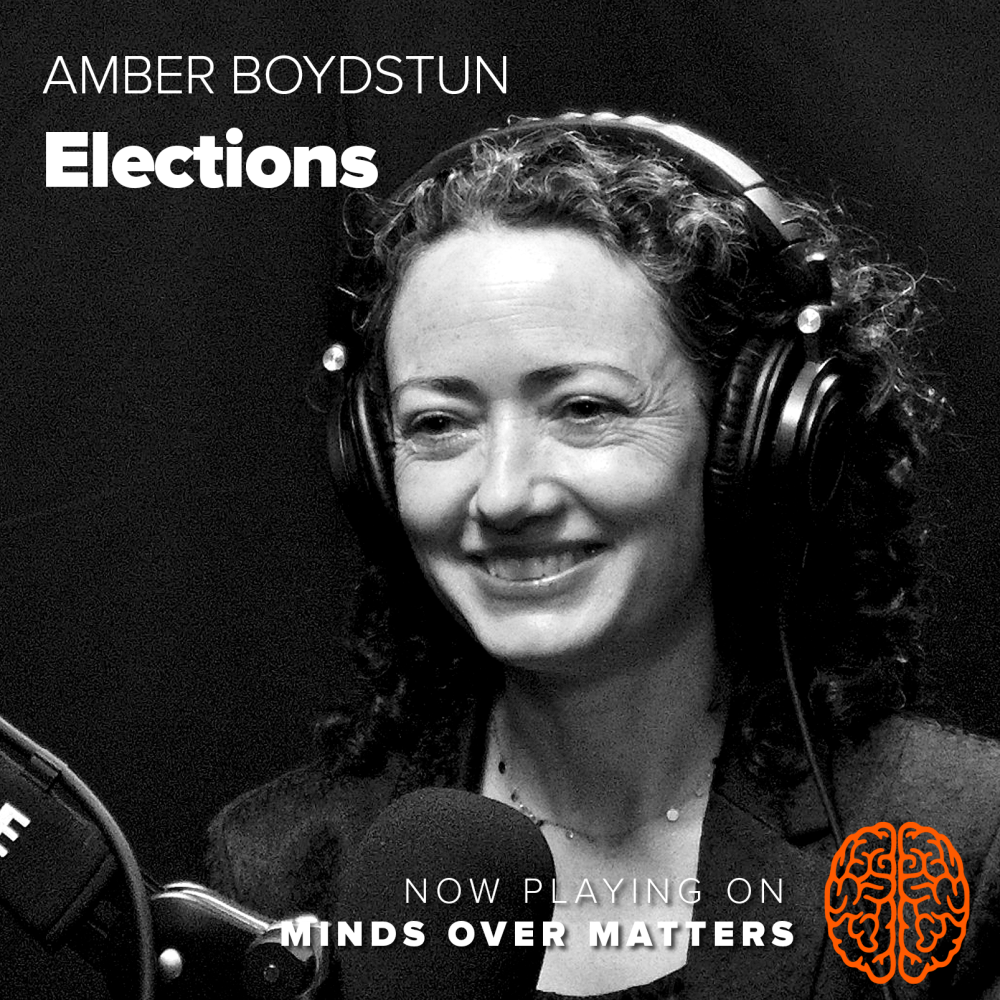 Smiling woman wearing headphones in podcast studio; orange brain logo at bottom right