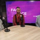 Three smiling adults seated around a round table with microphones and purple studio backdrop