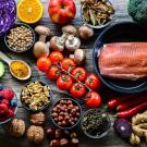 An  overhead shot of a table of food, which mainly includes fruits, veggies and lean proteins. 