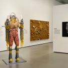 Gallery view of a mannequin sculpture and two wall pieces